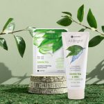 Wooden slice podium and green leaves on a green moss background. Premium scene for product promotion, beauty, natural eco cosmetic. Showcase, display case.